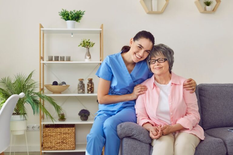 Caregiver hugging an older woman in a senior living community